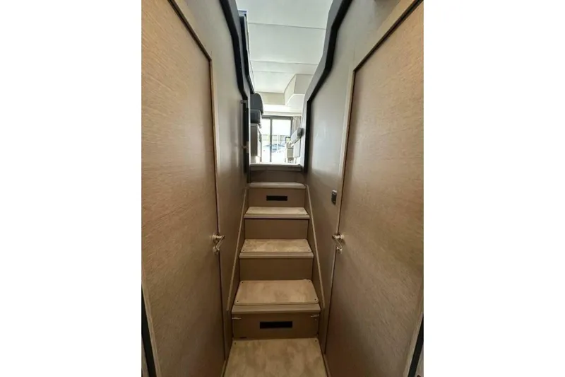 Our Trade Yacht Photos Pics Interior hallway of 2024 Prestige 460 yacht with wooden stairs and doors.
