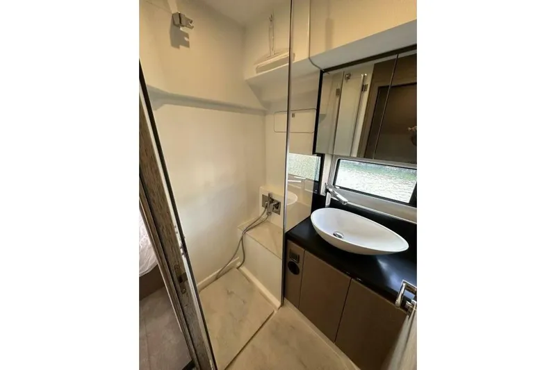 Our Trade Yacht Photos Pics Modern bathroom interior in 2024 Prestige 460 yacht, featuring sleek sink and cabinetry.