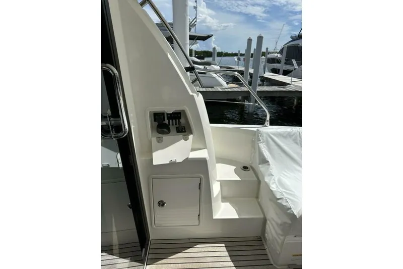 Our Trade Yacht Photos Pics 2024 Prestige 460 yacht deck with control panel and marina view.