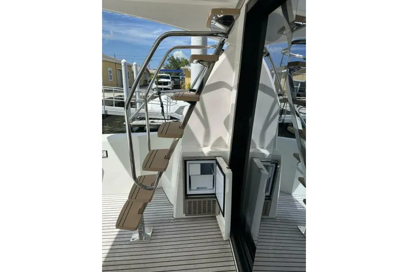Our Trade Yacht Photos Pics Stainless steel staircase on 2024 Prestige 460 yacht deck, featuring open storage compartments.