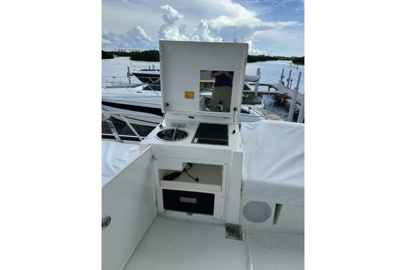 Our Trade Yacht Photos Pics Outdoor kitchen on a 2024 Prestige 460 yacht, featuring a grill and storage.