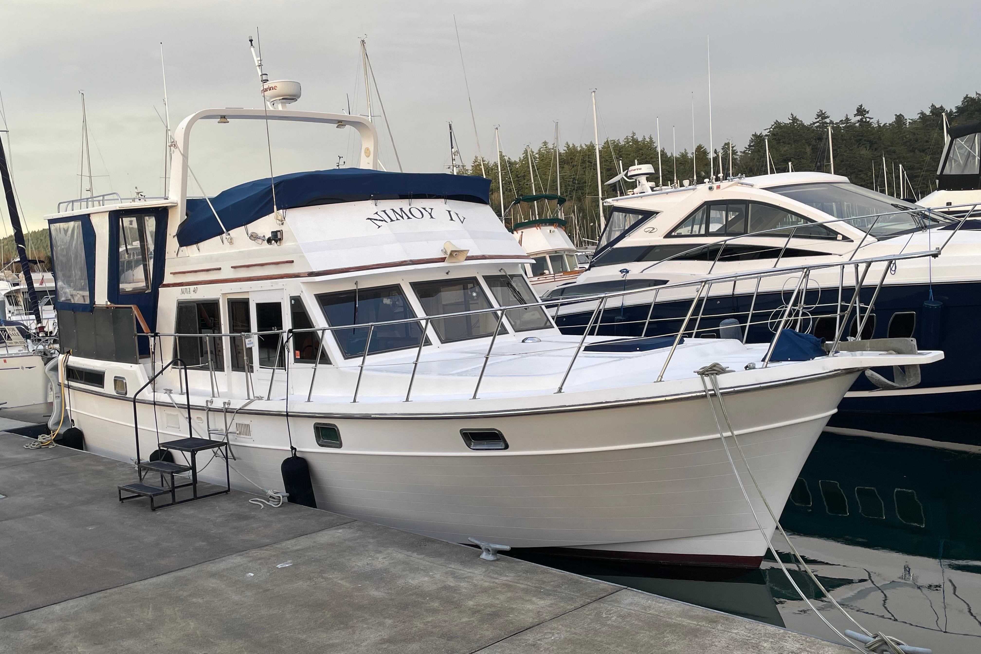 1985 Nova 40 Sundeck Aft Cabin yacht docked at marina, surrounded by other boats.