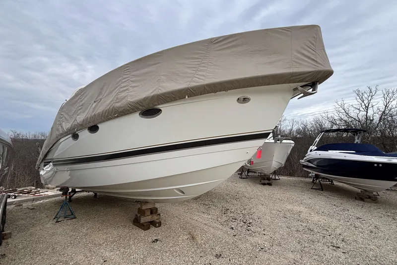  Yacht Photos Pics 2005 Formula 31 Performance Cruiser covered and stored on gravel lot.