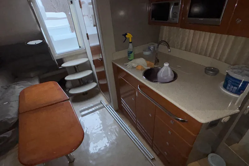  Yacht Photos Pics Interior of a 2005 Formula 31 Performance Cruiser with kitchenette and seating area.