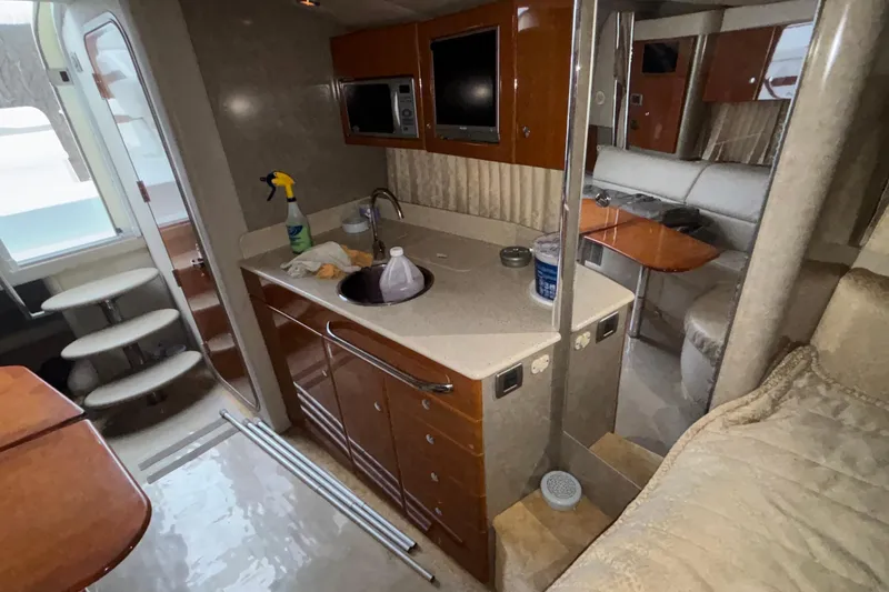  Yacht Photos Pics Interior of a 2005 Formula 31 Performance Cruiser with kitchenette and seating area.