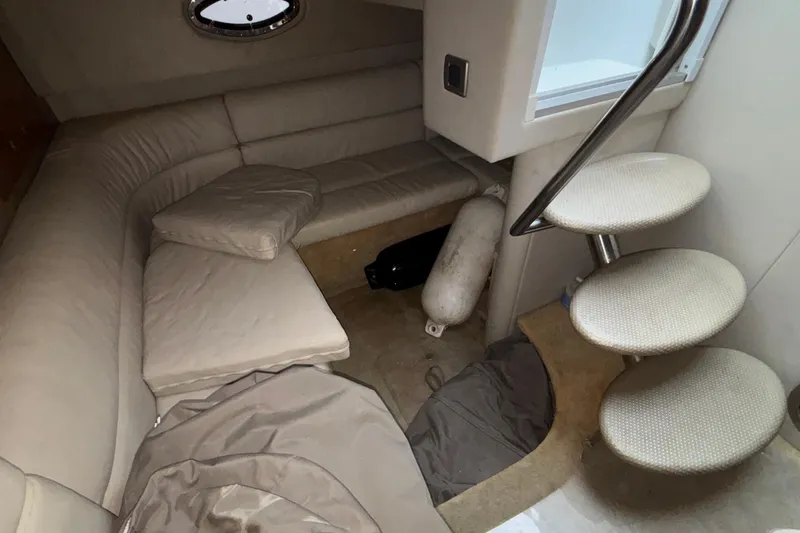  Yacht Photos Pics Interior of 2005 Formula 31 Performance Cruiser with beige seating and spiral staircase.