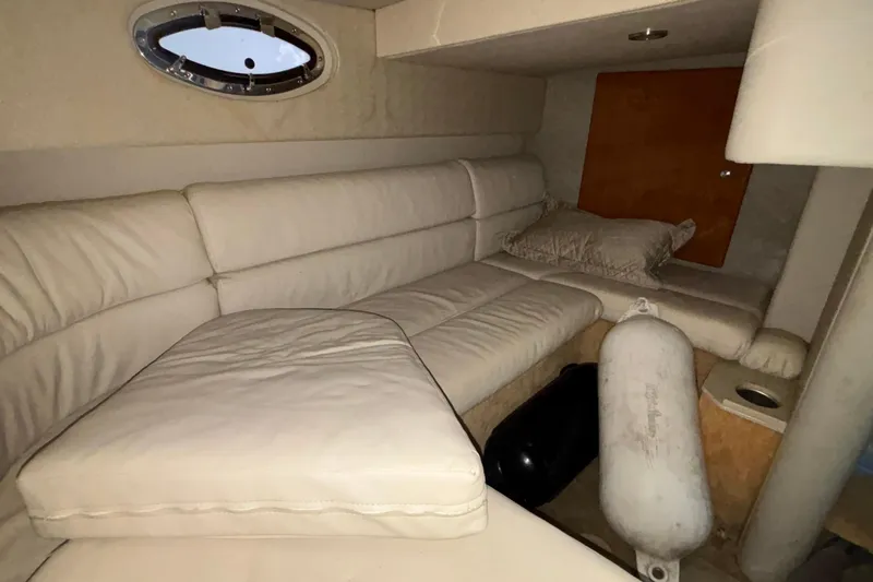  Yacht Photos Pics 2005 Formula 31 Performance Cruiser interior with white leather seating and porthole window.