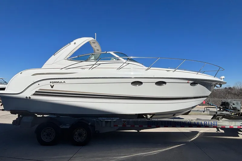  Yacht Photos Pics 2005 Formula 31 Performance Cruiser boat on trailer under clear blue sky.