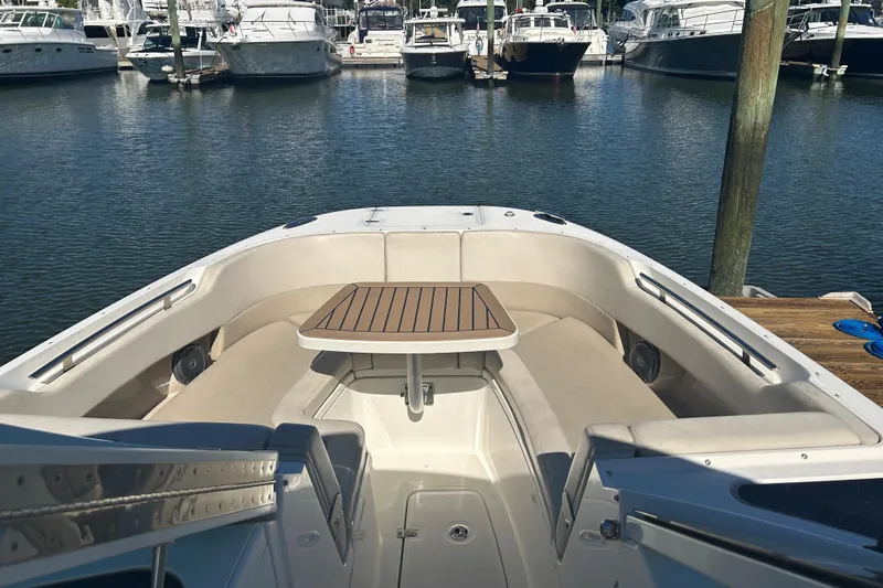 Ship Happens Yacht Photos Pics 2018 Boston Whaler 320 Vantage boat interior with seating and table at marina.