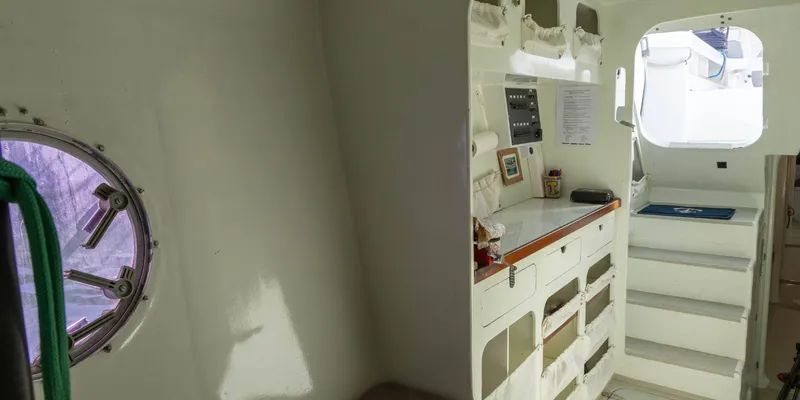 Maxicat Victoria Yacht Photos Pics Interior of a 2000 Multiplast fast cruising conversion maxi catamaran, featuring stairs and storage.