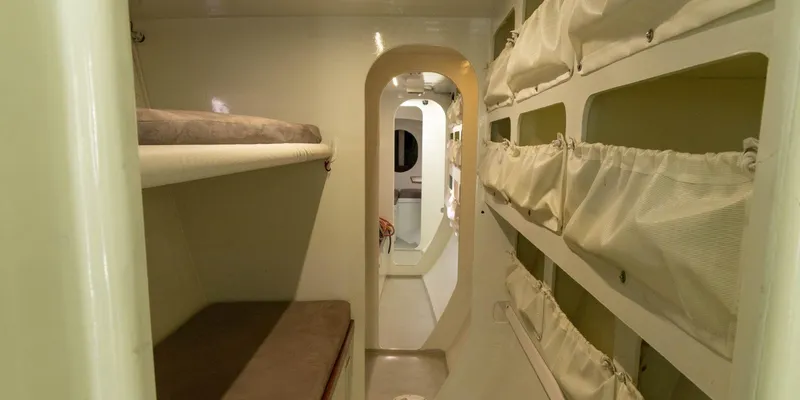 Maxicat Victoria Yacht Photos Pics Interior of 2000 Multiplast Maxi Catamaran, featuring cozy sleeping quarters and storage.