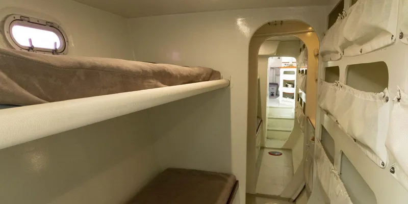 Maxicat Victoria Yacht Photos Pics Interior of 2000 Multiplast Maxi Catamaran with cozy bunk beds and storage.