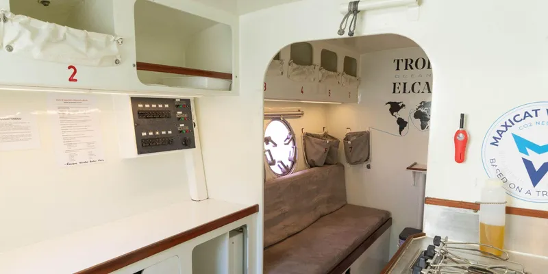 Maxicat Victoria Yacht Photos Pics Interior of a 2000 Multiplast Maxi Catamaran, featuring cozy seating and nautical decor.