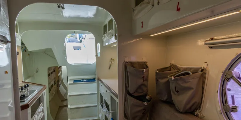 Maxicat Victoria Yacht Photos Pics Interior of 2000 Multiplast Maxi Catamaran, featuring compact kitchen and storage areas.