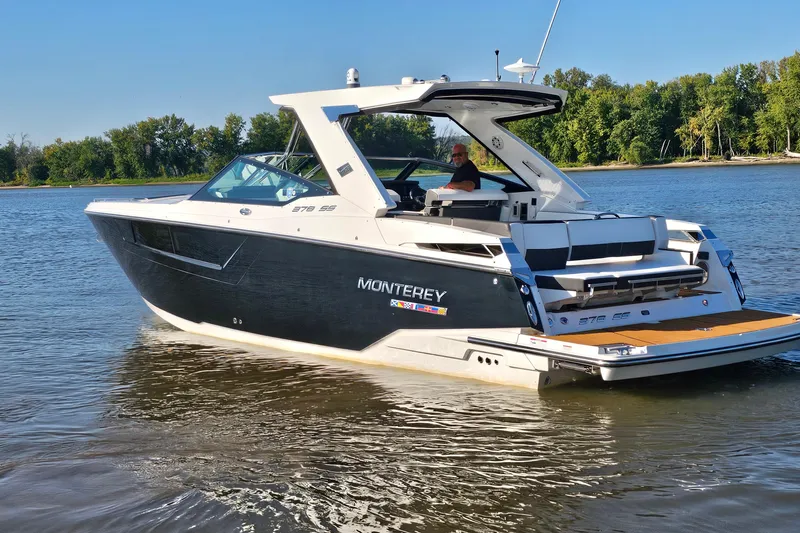  Yacht Photos Pics 2022 Monterey 378SS Super Sport boat cruising on a calm river with lush green trees.