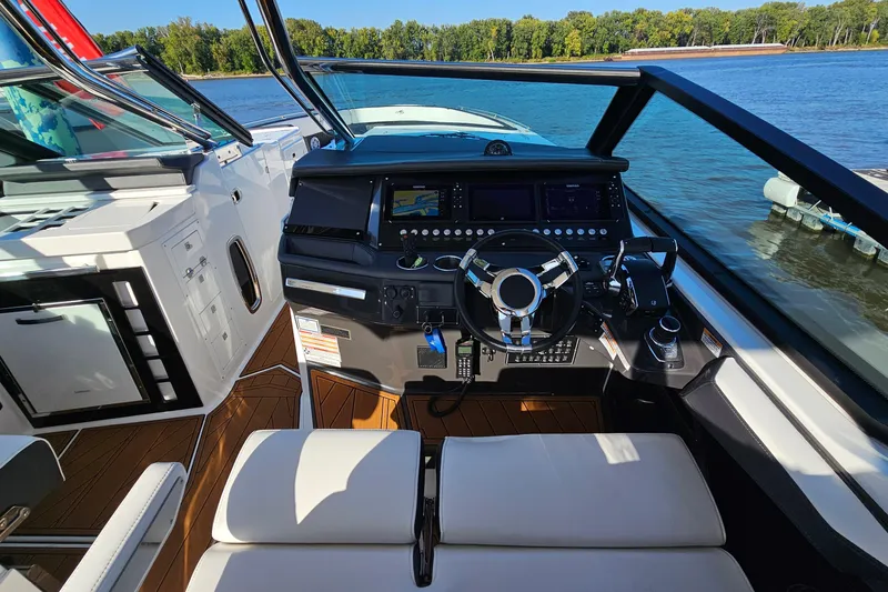  Yacht Photos Pics Cockpit of 2022 Monterey 378SS Super Sport boat with modern controls and scenic water view.