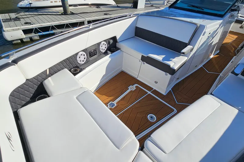  Yacht Photos Pics 2022 Monterey 378SS Super Sport boat interior with white seating and wood-style flooring.