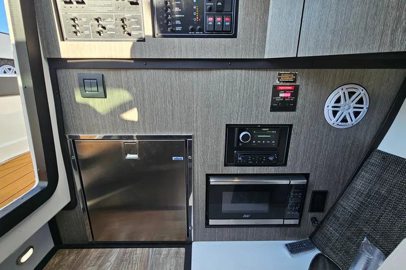  Yacht Photos Pics 2022 Monterey 378SS Super Sport interior with control panel, microwave, and speaker.