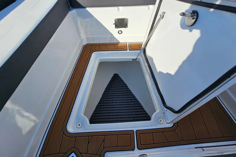  Yacht Photos Pics 2022 Monterey 378SS Super Sport boat storage compartment with open hatch and wood-like flooring.