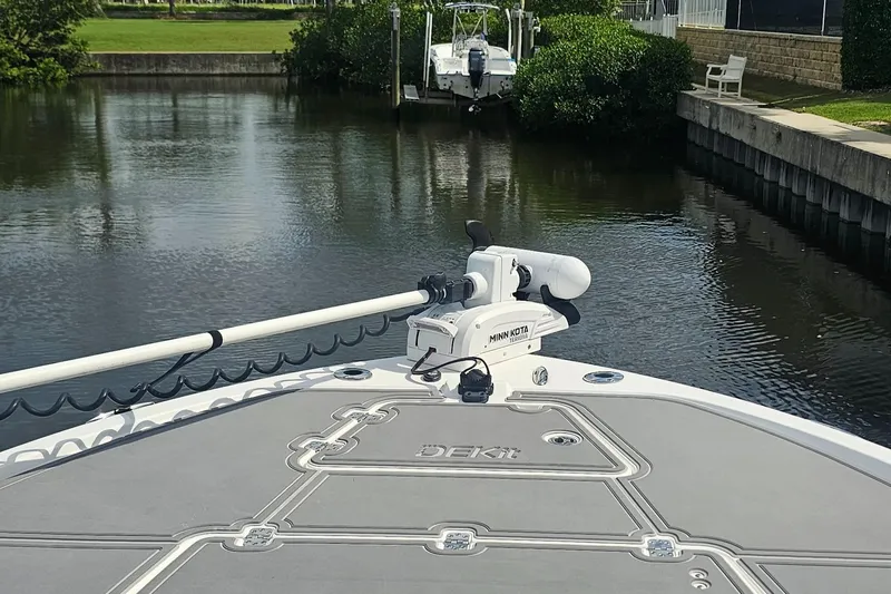  Yacht Photos Pics 2023 Caymas 28 HB Twin boat with Minn Kota trolling motor on calm waterway.