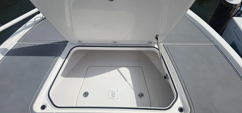  Yacht Photos Pics 2023 Caymas 28 HB Twin boat storage compartment open on deck.