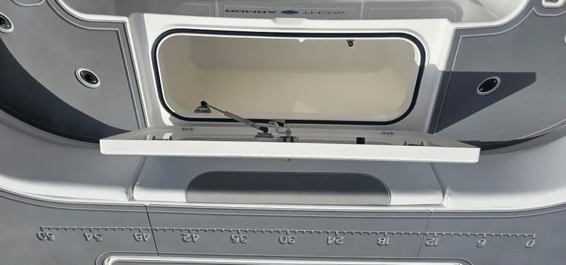  Yacht Photos Pics 2023 Caymas 28 HB Twin boat storage compartment with open lid and measurement markings.