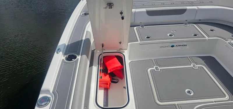  Yacht Photos Pics 2023 Caymas 28 HB Twin boat deck with storage compartment and life jackets.