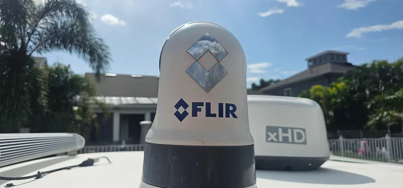  Yacht Photos Pics FLIR radar on 2023 Caymas 28 HB Twin boat, sunny day, palm trees in background.