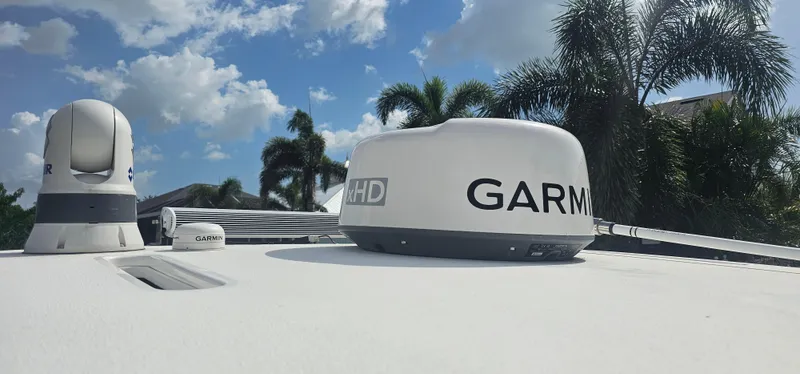  Yacht Photos Pics 2023 Caymas 28 HB Twin boat with Garmin radar equipment under a clear sky.