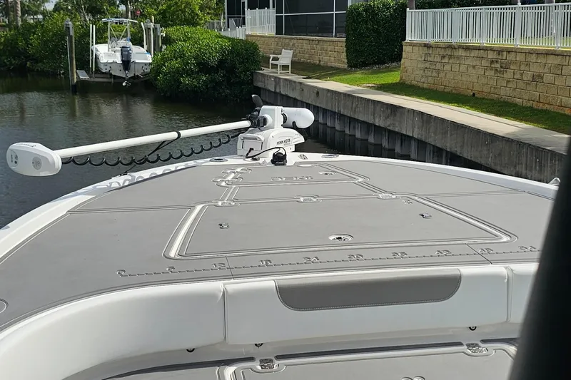  Yacht Photos Pics 2023 Caymas 28 HB Twin boat deck with trolling motor, docked by a canal.