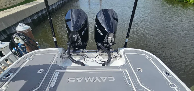  Yacht Photos Pics 2023 Caymas 28 HB Twin boat with dual Mercury engines docked by the water.