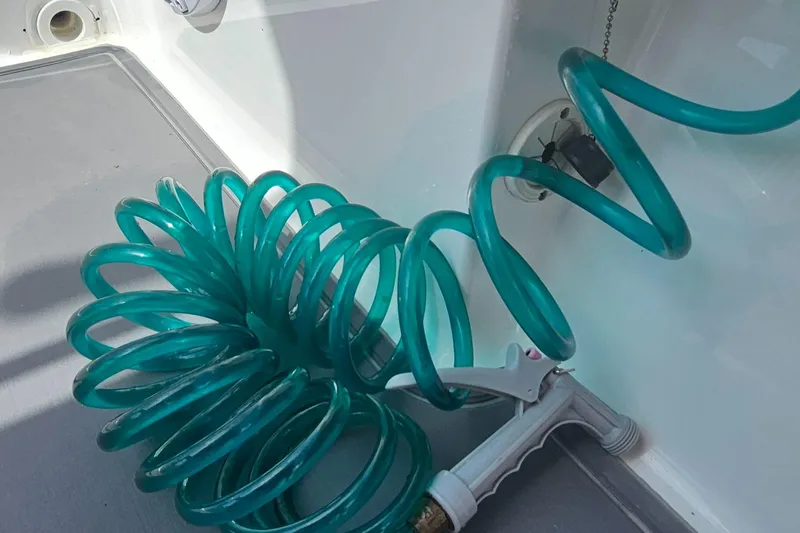  Yacht Photos Pics Coiled green hose on 2023 Caymas 28 HB Twin boat deck.