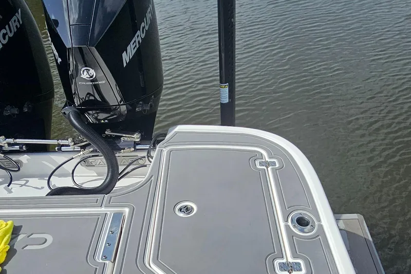  Yacht Photos Pics 2023 Caymas 28 HB Twin boat with Mercury engines on calm water.