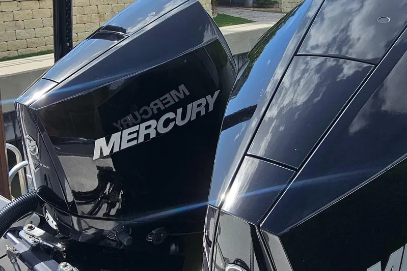  Yacht Photos Pics Twin Mercury outboard engines on a 2023 Caymas 28 HB boat, reflecting sunlight.