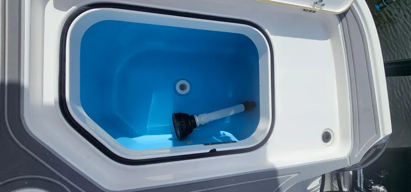  Yacht Photos Pics Livewell compartment on 2023 Caymas 28 HB Twin boat, featuring a blue interior.