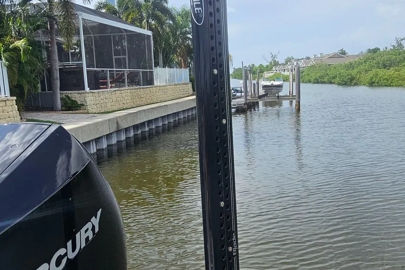  Yacht Photos Pics 2023 Caymas 28 HB Twin boat docked near waterfront home with Mercury engine.