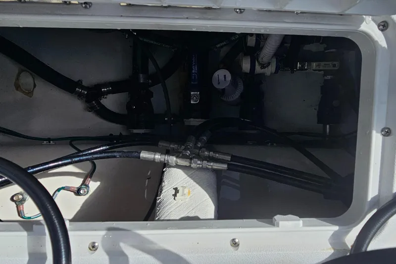  Yacht Photos Pics Interior view of 2023 Caymas 28 HB Twin boat showing mechanical components and wiring.