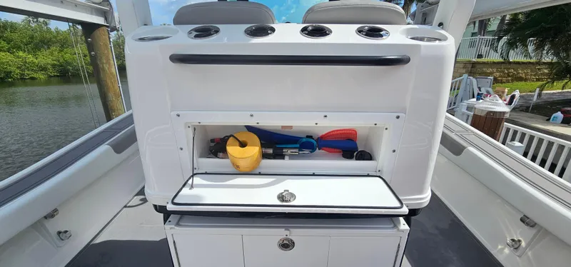  Yacht Photos Pics 2023 Caymas 28 HB Twin boat storage compartment with fishing gear and accessories.
