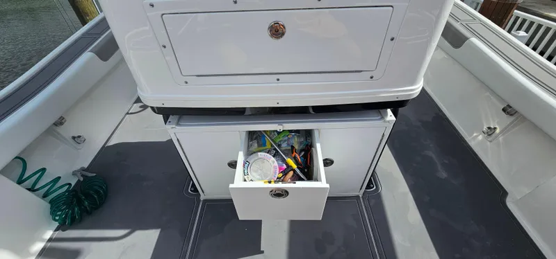  Yacht Photos Pics 2023 Caymas 28 HB Twin boat with open storage drawer containing fishing gear.
