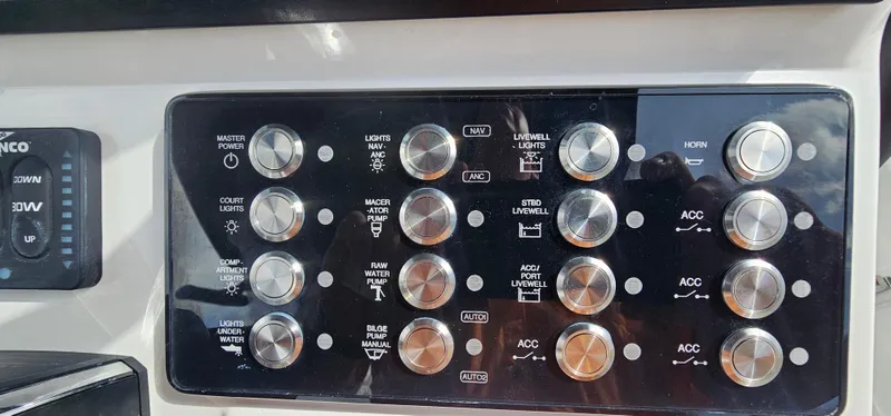  Yacht Photos Pics Control panel of 2023 Caymas 28 HB Twin boat with various switches and buttons.