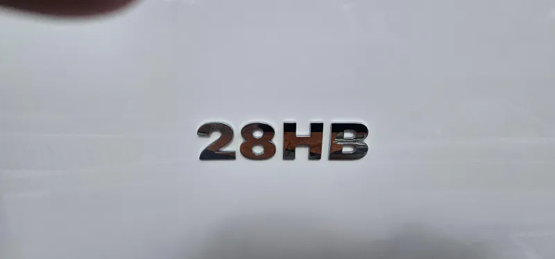  Yacht Photos Pics 2023 Caymas 28 HB Twin model emblem on white surface.