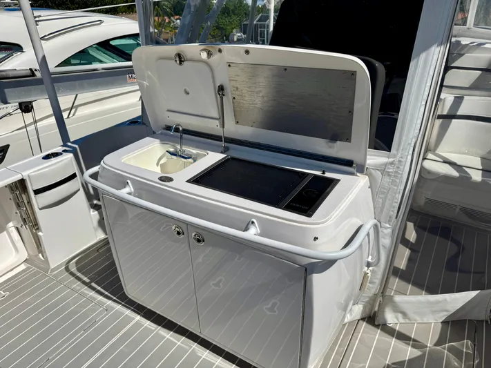  Yacht Photos Pics Outdoor kitchenette on 2021 Intrepid 409 Valor boat with sink and grill.