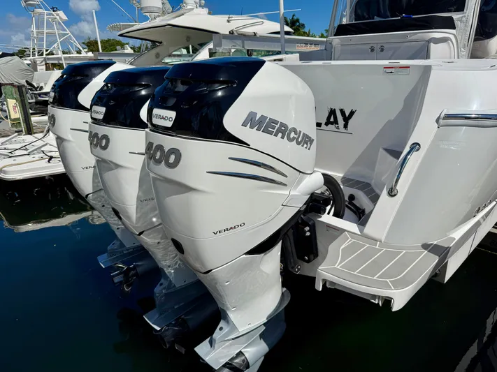  Yacht Photos Pics 2021 Intrepid 409 Valor with triple Mercury outboard engines docked at marina.