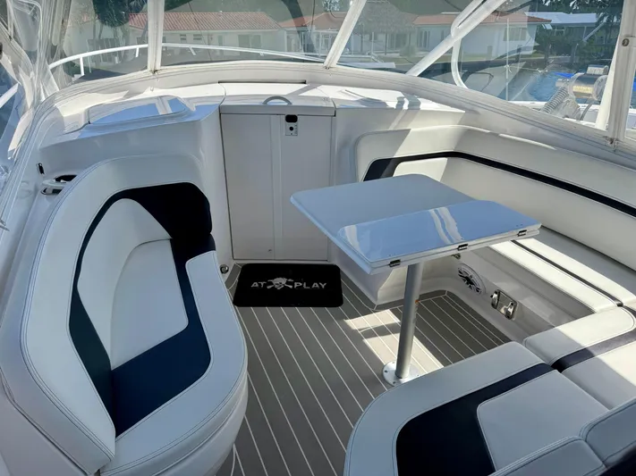  Yacht Photos Pics Luxurious interior of 2021 Intrepid 409 Valor boat with sleek seating and table.