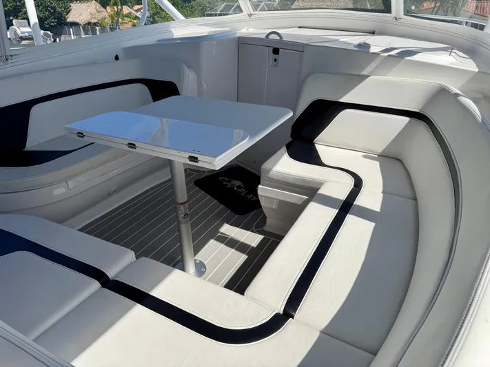  Yacht Photos Pics Luxurious seating area on 2021 Intrepid 409 Valor boat with sleek table design.
