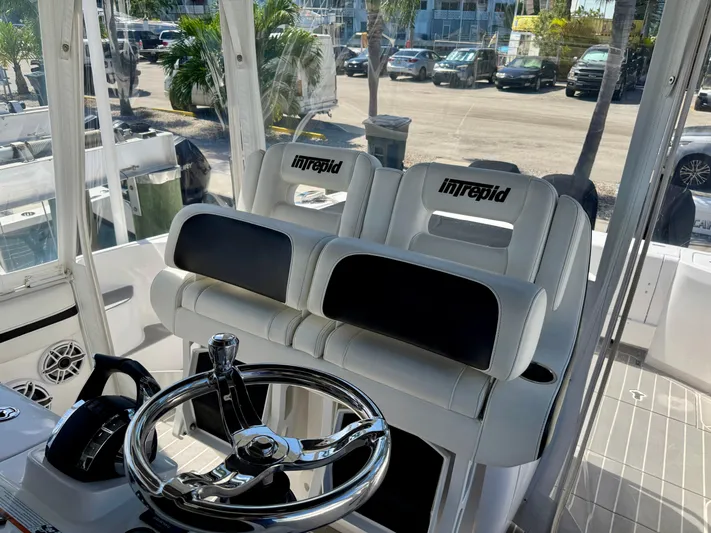  Yacht Photos Pics 2021 Intrepid 409 Valor boat interior with steering wheel and seating.