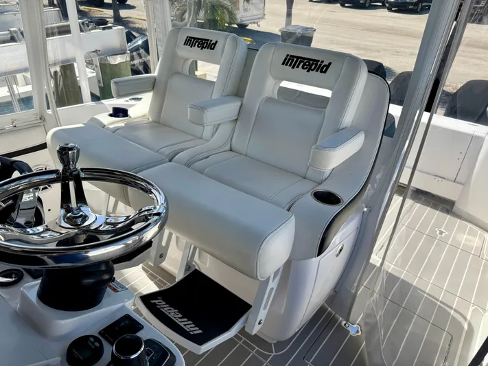  Yacht Photos Pics 2021 Intrepid 409 Valor boat interior with white leather seats and steering wheel.
