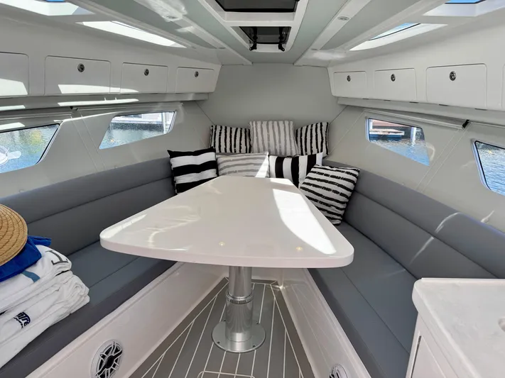  Yacht Photos Pics Luxurious interior of 2021 Intrepid 409 Valor boat with striped cushions and sleek design.