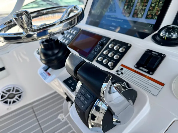  Yacht Photos Pics Close-up of 2021 Intrepid 409 Valor boat controls and steering wheel.