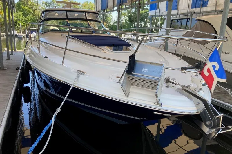 Co-motion Yacht Photos Pics 2008 Sea Ray 44 Sundancer yacht docked, featuring sleek design and vibrant flag.